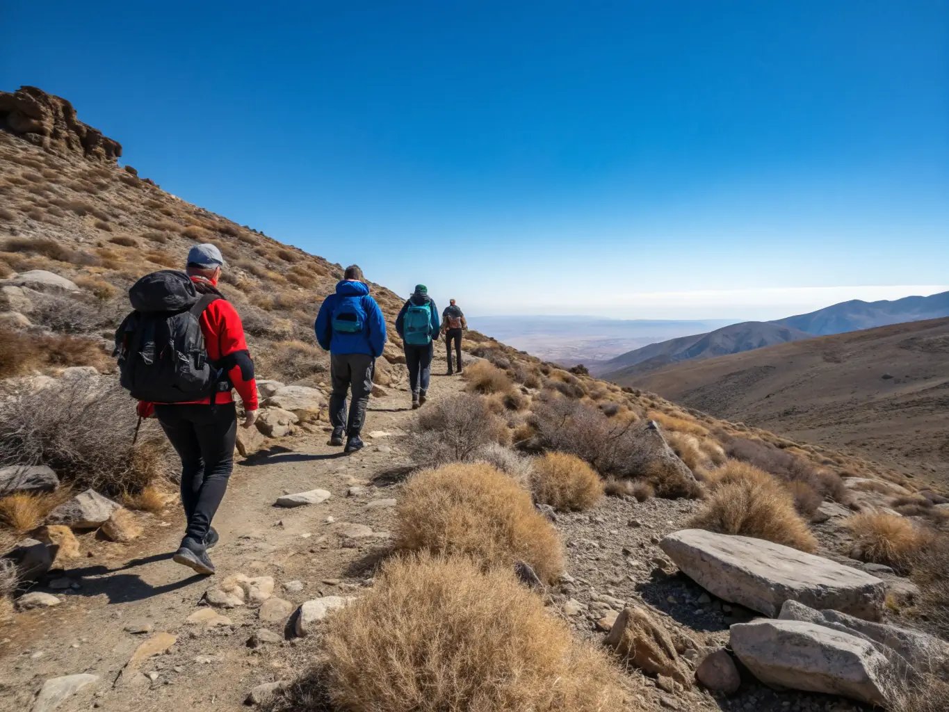 A scenic view of hikers traversing a mountain trail in the Luberon region, showcasing the diverse landscapes and natural beauty of the area during an A.R.P.F. excursion.